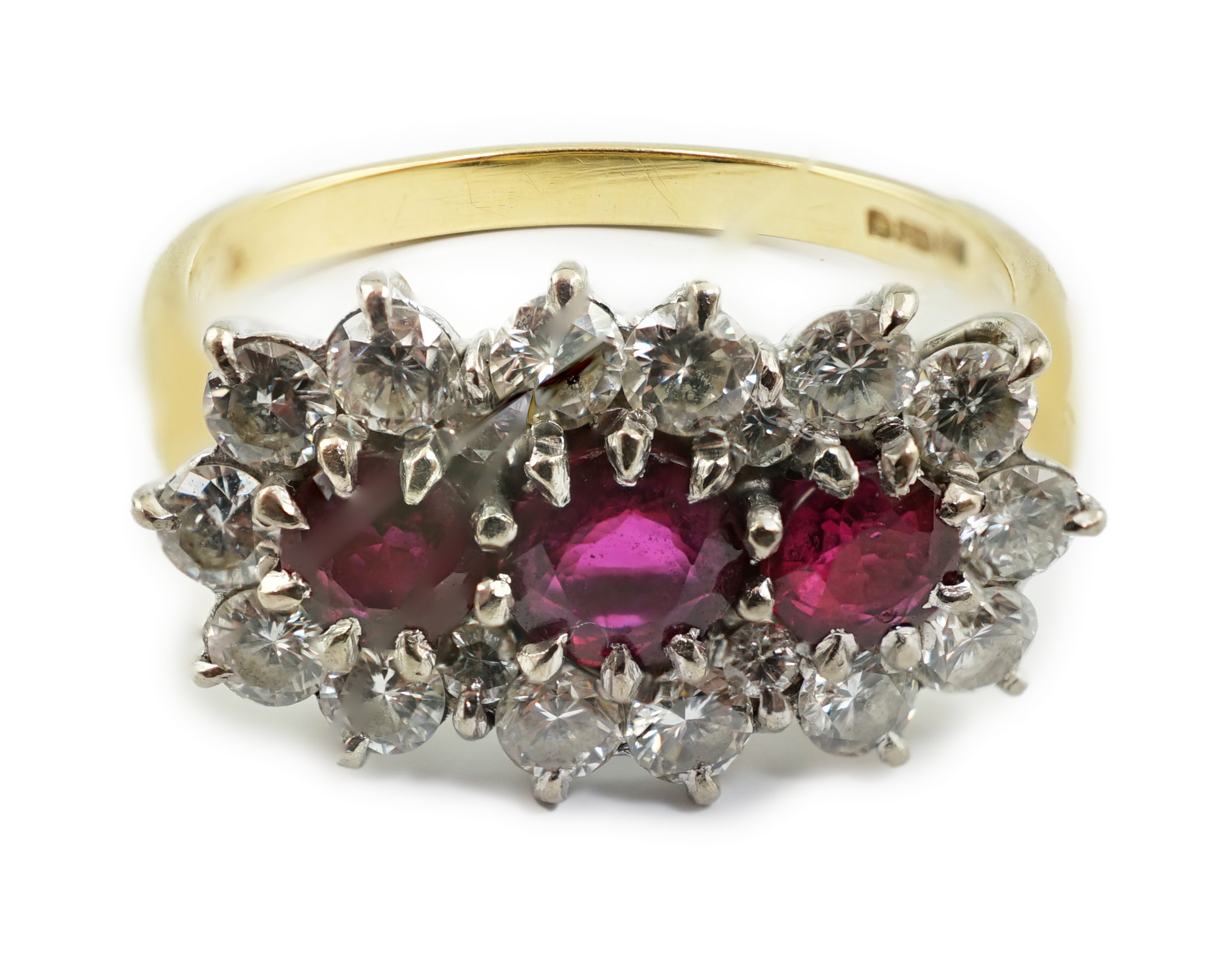 A modern 18ct gold, ruby and diamond set triple cluster ring